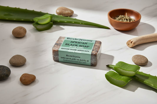 Bar of African Black Soap with 'Reviv2Grow' label on a marble surface