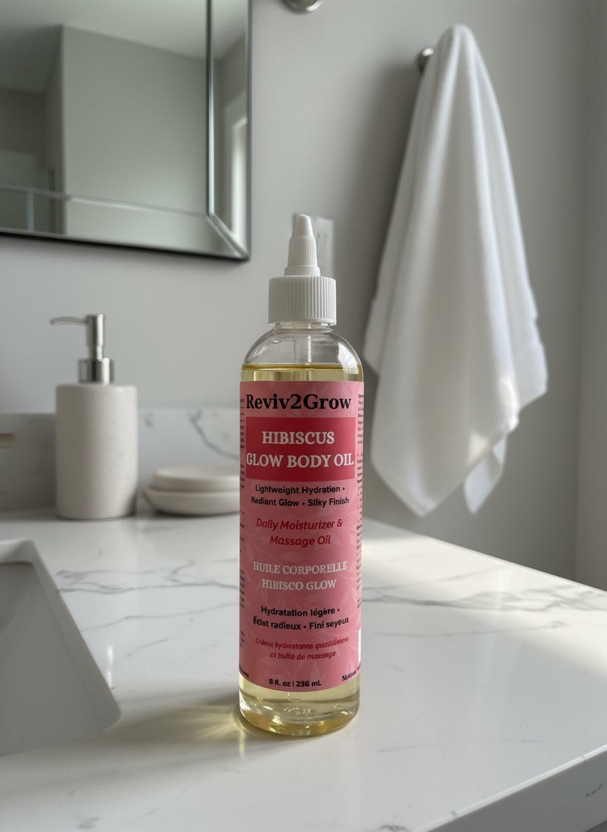 Reviv2Grow hibiscus glow body oil bottle on a bathroom counter