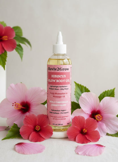 Bottle of Reviv2Grow Hibiscus Glow Body Oil on a gray background