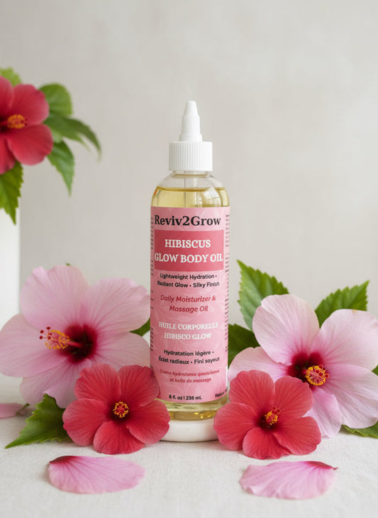 Bottle of Reviv2Grow Hibiscus Glow Body Oil on a gray background