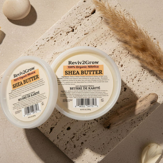 Two containers of Reviv2Grow Shea Butter on a textured surface with decorative elements.