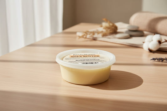 Container of body butter on a wooden surface with a blurred background