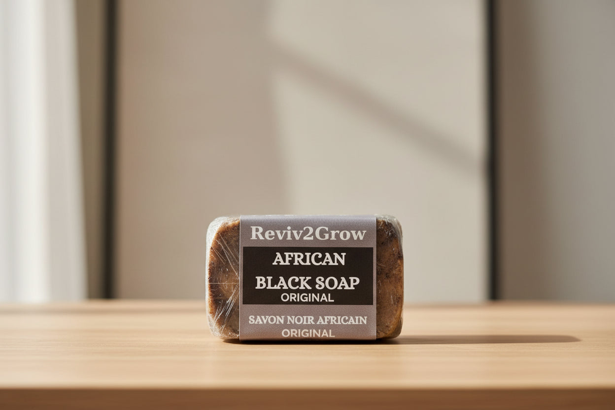 Bar of African Black Soap with 'Reviv2Grow' label on a marble surface