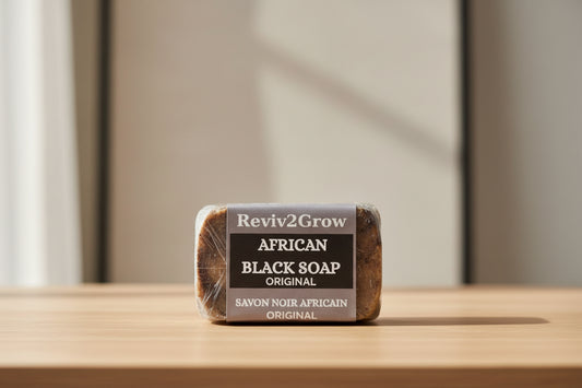 Bar of African Black Soap with 'Reviv2Grow' label on a marble surface