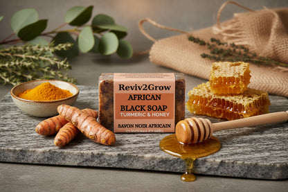 Bar of Reviv2Grow African Black Soap with Turmeric & Honey on a marble surface