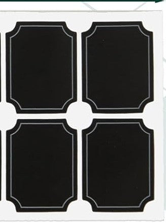 Four black square stickers with decorative white borders on a white background