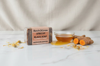 Bar of Reviv2Grow African Black Soap on a marble surface