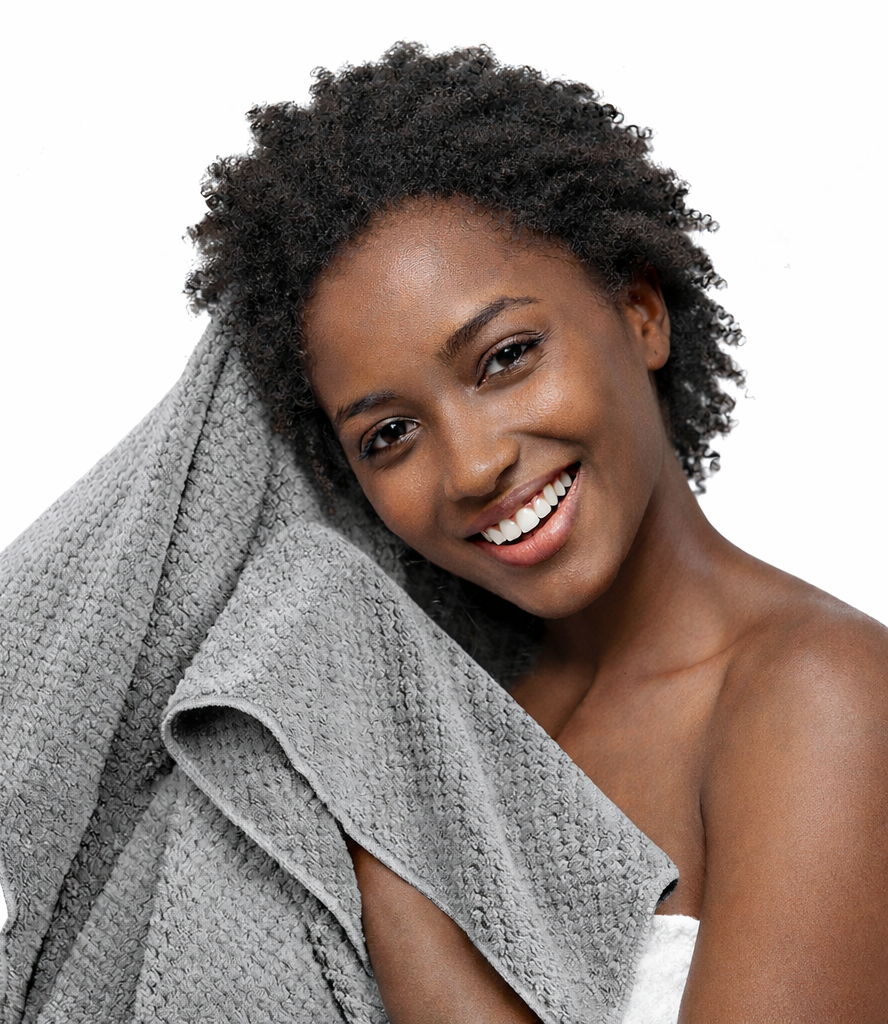 Woman with a gray towel draped over her shoulder against a white background