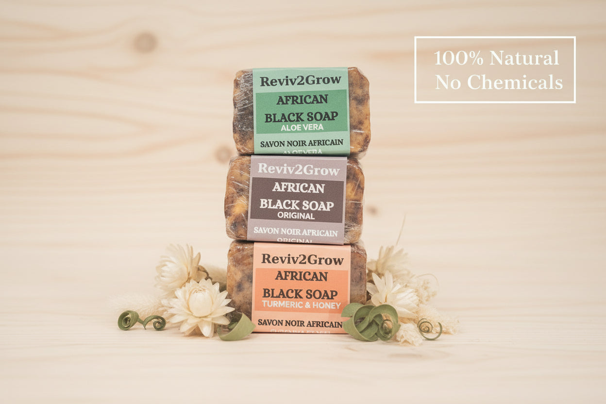 Three bars of African Black Soap from Reviv2Grow on a marble surface.