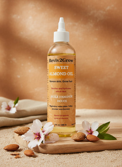 Bottle of Reviv2Grow Sweet Almond Oil on a neutral background