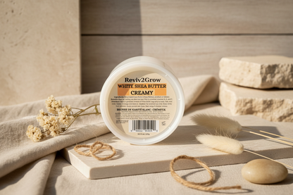 Reviv2Grow White Shea Butter Creamy container on a wooden surface with natural elements.