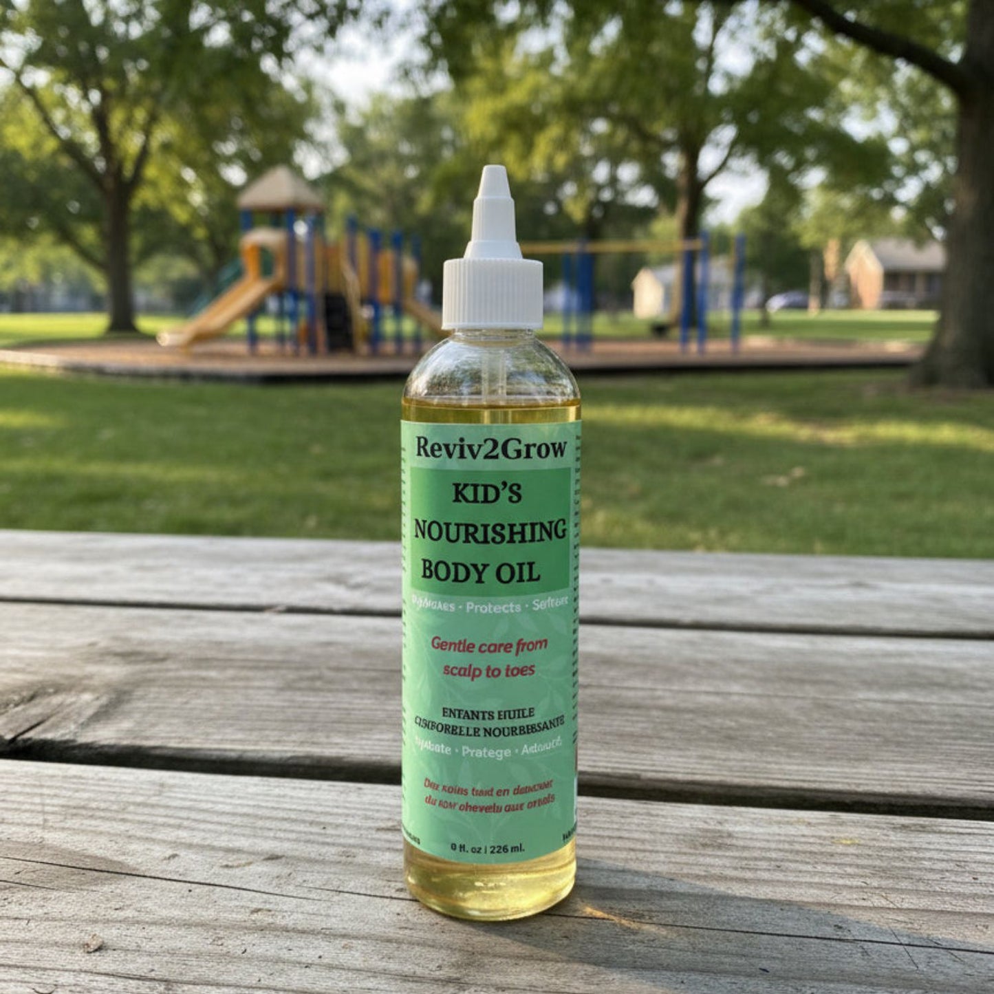 Bottle of Reviv2Grow Kid's Nourishing Body Oil on a neutral background
